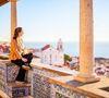 Young woman enjoying breathtaking view over central Lisbon in Portugal from beautiful terrace decorated with traditional portuguese tiles azulejos.jpg