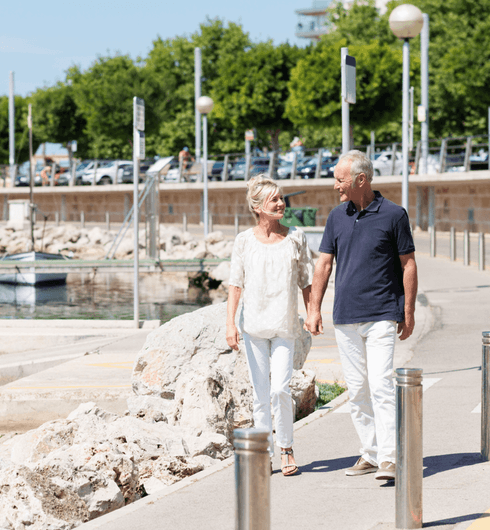 Retired couple walking in a harbour